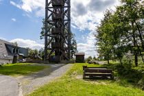 Zugang zum Aussichtsturm - Der nächste Parkplatz ist 400 Meter entfernt. Unten am Turm, der neben einem Wohnhaus liegt, gibt es Sitzbänke. • © ummeteck.de - Silke Schön