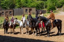 Elspe Festival 2023: Unter Geiern - Hauptdarsteller - Bilder - Die Hauptdarsteller auf ihren wunderbaren Pferden von rechts nach links: Martin Krah (Old Shatterhand) - Jean-Marc Birkholz (Winnetou) - Tim Forssman (Schiba-bigk) - Sebastian Kolb (Weller) - Jonathan Elias Weiske (Bloody Fox) - Sarah Gösser (Sarah) - James Bürkner (Jim Preston) • © ummet-eck.de - Silke Schön